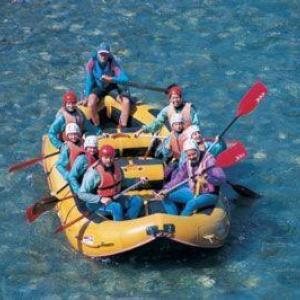 Several people sit in a yellow dinghy